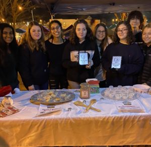 Stefanie Carnthan, Foods Teacher at CHS, poses with her students at the Holiday Bake Shop. 